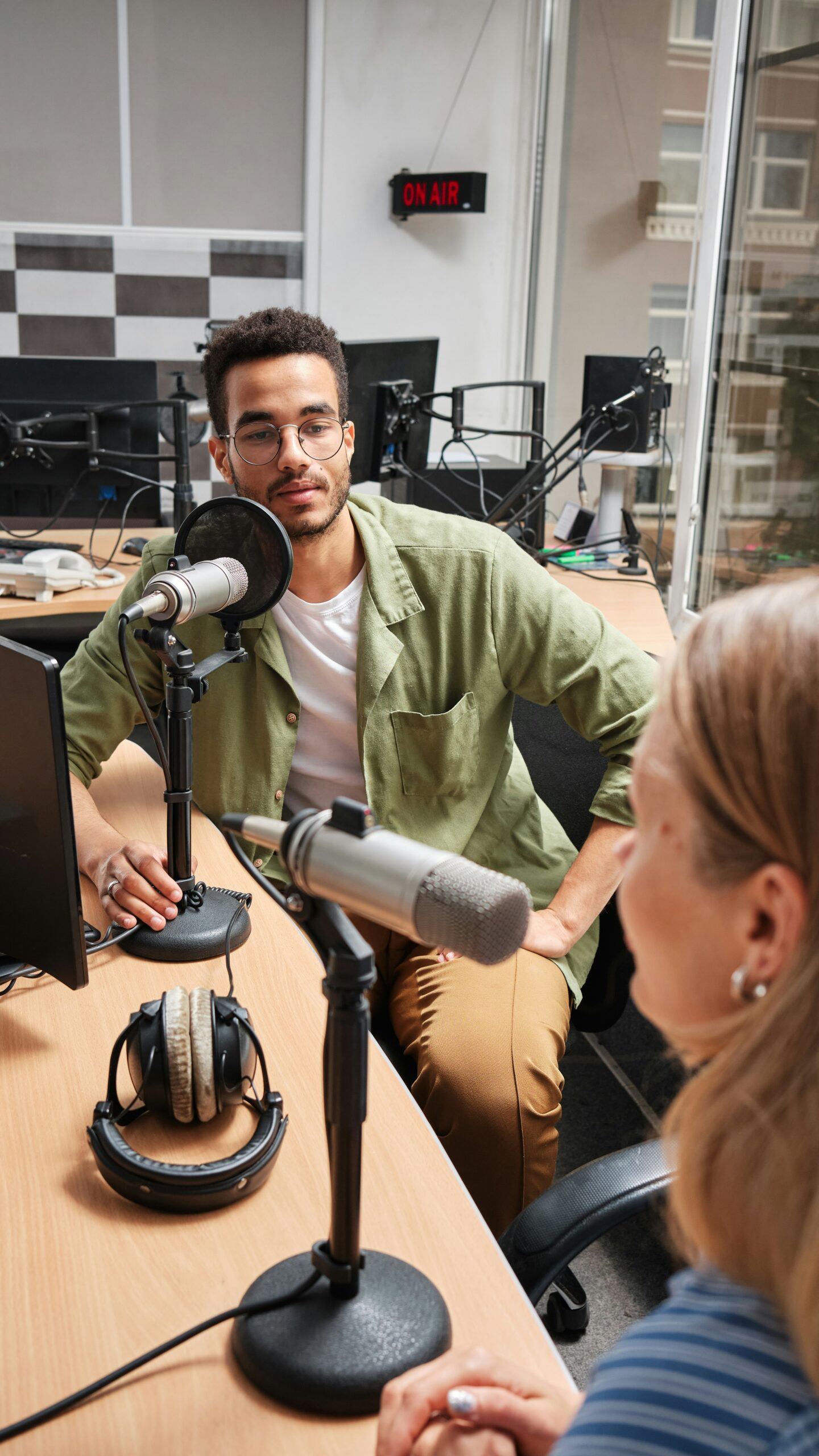 man interviewing woman in podcast studio
