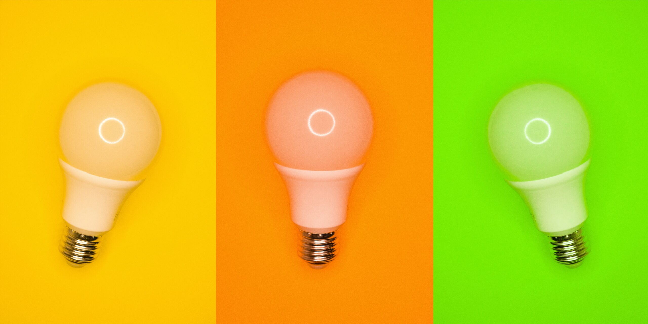 three light bulbs against colourful background